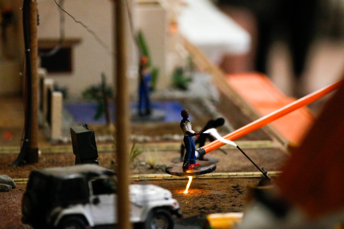 A miniature figurine is displayed in a scene showing how fire creates electricity