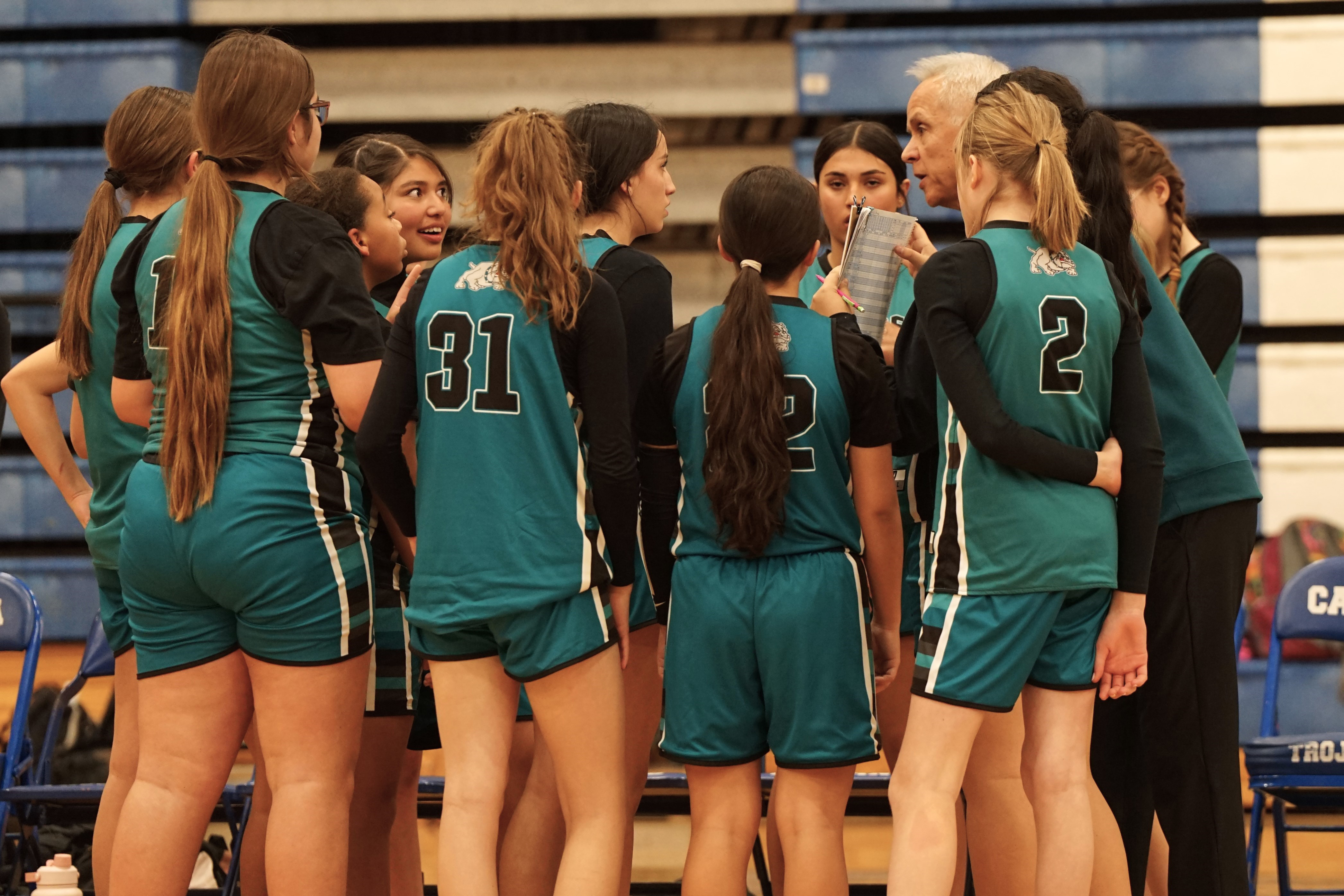 The Bulldogs huddle around their coach