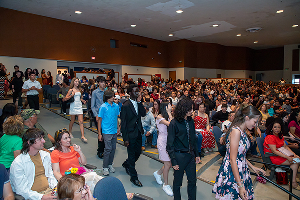 Students walk into the auditorium
